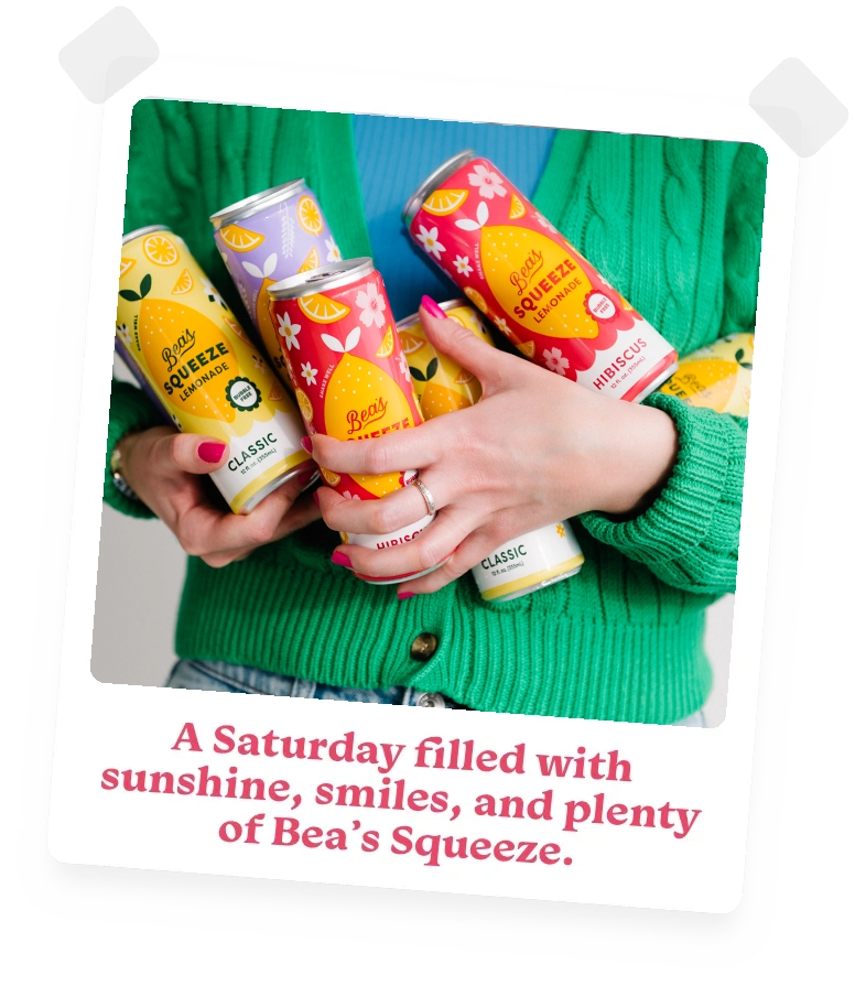 photo of a smiling young woman sitting outside holding a bottle of Bea's Squeeze lavender lemonade with the caption A Saturday filled with sunshine, smiles, and plenty of Bea's Squeeze